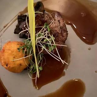 A petite filet mignonette, with a rebaked truffle potato ball, and Demi glaze sauce.