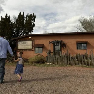 a man and a little girl holding hands