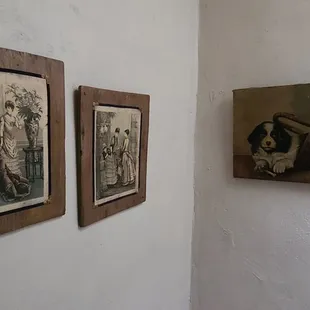 a couple of old photographs hanging on the wall