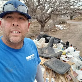 Me on top if trash pile in our truck