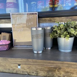 a planter and a cup on a shelf