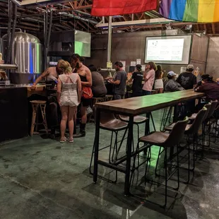 a group of people standing around a bar