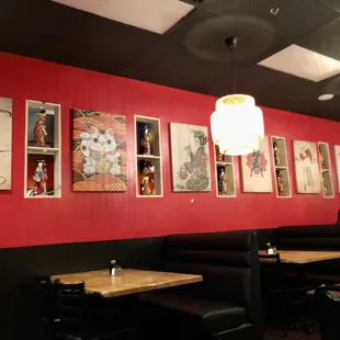 a red wall with pictures on it