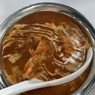 a bowl of curry with a spoon