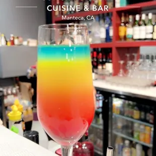 a colorful cocktail in a wine glass