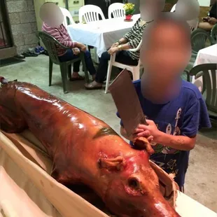 a man cutting a large piece of meat