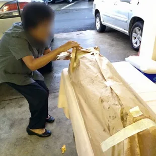 a man cutting a sandwich