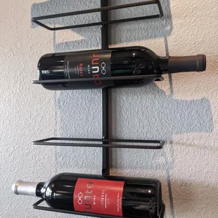 three bottles of wine on a wall
