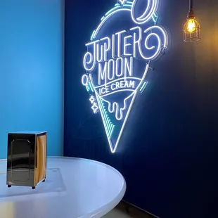 a neon sign on the wall