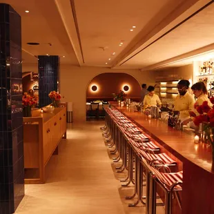 a restaurant with a long wooden bar
