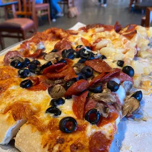 a pizza with pepperoni and olives