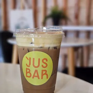 a cup of iced coffee on a table