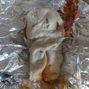 Lunch burrito with chicken. Became less handheld and more of a fork option after it hit the ground lol. Careful with the paper bag.