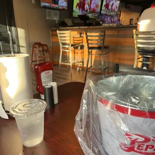 a plastic bag and a drink on a table