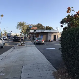 There are a couple outdoor tables on the other side by sidewalk