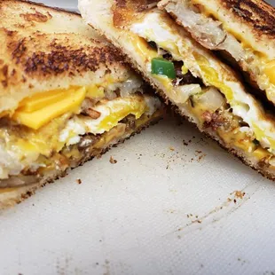 Our Breakfast Sandwich on Texas Toast with cheese, egg, peppers and onion - your choice of ham, bacon or sausage