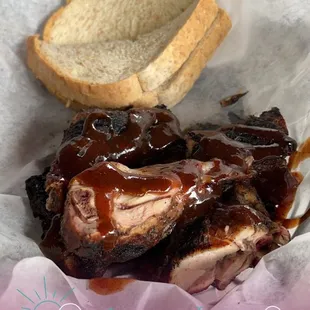 a basket of ribs and a sandwich