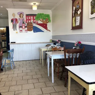 the interior of a restaurant with tables and chairs