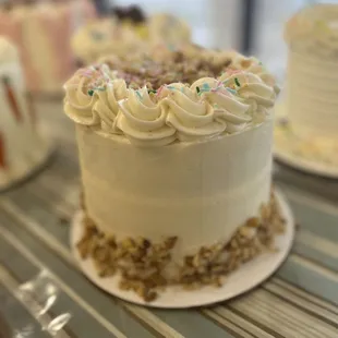 a cake with white frosting and sprinkles