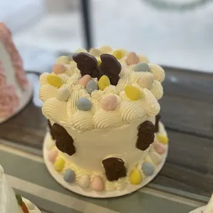 a cake with white frosting and colorful candies