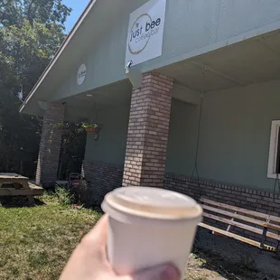 a hand holding a cup of coffee