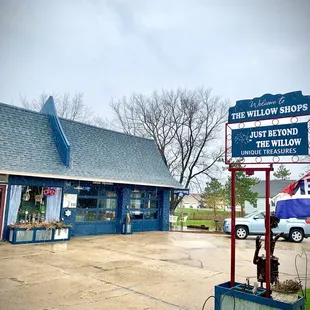 a blue building with a sign for willow shops