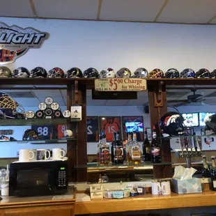 a bar with helmets on the wall