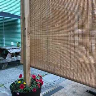 Cute little bamboo privacy screens on both sides-love the little flowers too!