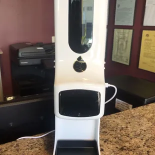 Takes your temperature and sanitizes your hands