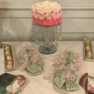 Baby shower table spread with Rosette ombré cake, sugar cookies, and french macarons