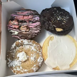 Neapolitan brownie top left, black and gold cookie, cafe au lait and beignet, and petit four cookie. This was September&apos;s rotating menu