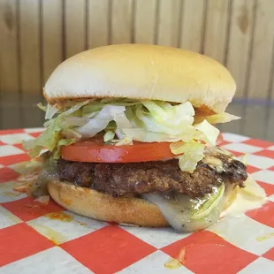 a hamburger with lettuce, tomato, and cheese