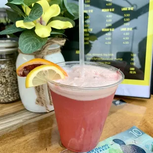 a drink with a straw and a lemon slice