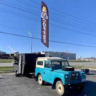 a blue land rover parked in a parking lot