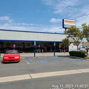a red car parked in front of a store
