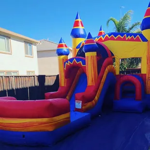 Our colorful combo bounce house. This jumper has a basketball hoop with a slide attached to it!