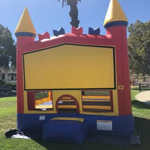 Colorful bounce house with a basketball hoop inside that the kids loved!