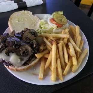 Mushroom Swiss burger with fries.