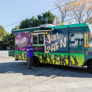 a person standing in front of a food truck