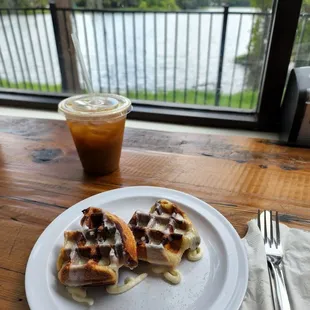 a plate of waffles and a drink