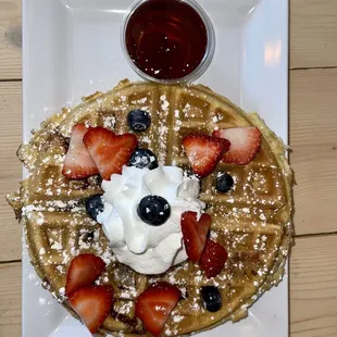 a waffle topped with strawberries and blueberries