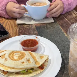 a plate of quesadillas and a cup of coffee