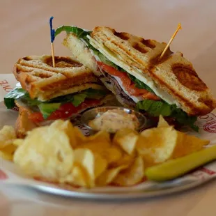 a sandwich and chips on a plate