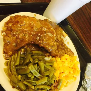 Smothered pork chops need more seasoning. Fried chicken is seasoned well, mixed greens and green beans are sooooo good!