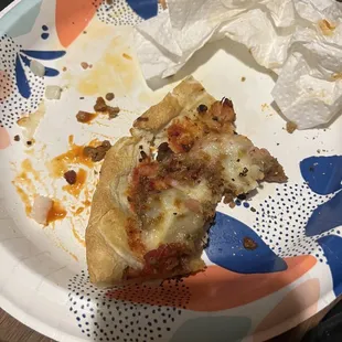 a half eaten pizza on a paper plate