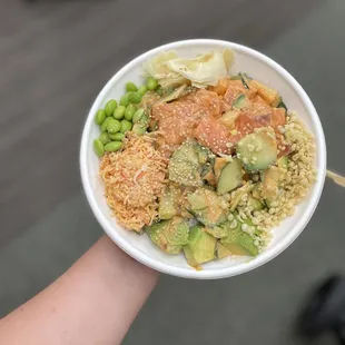 a person holding a bowl of food