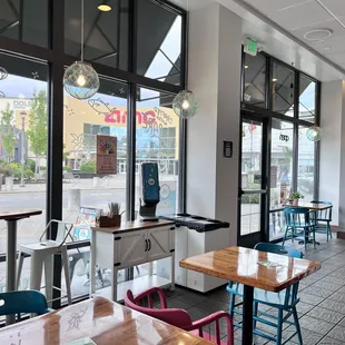 the inside of a restaurant with tables and chairs