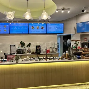 a restaurant counter with a variety of food items