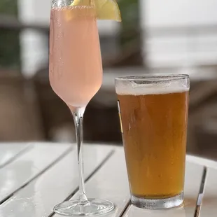 a pink drink and a glass of beer