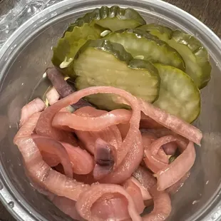 a bowl of pickles and onions